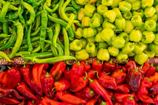 Mix of chili peppers, bell peppers, capi color assortment on vegetable market