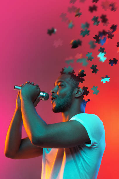 istock Modern collage of african man singing in microphone isolated over gradient background. Male head consist of puzzle pieces. 1341850286