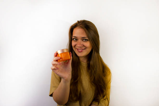 istock young beautiful woman uses face cream 1341851066