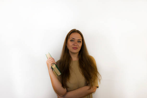 istock young beautiful woman with book, textbook 1341851143
