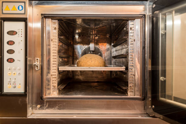 istock Loaf of fresh baked bread in open electrical oven in modern bakery 1341851233