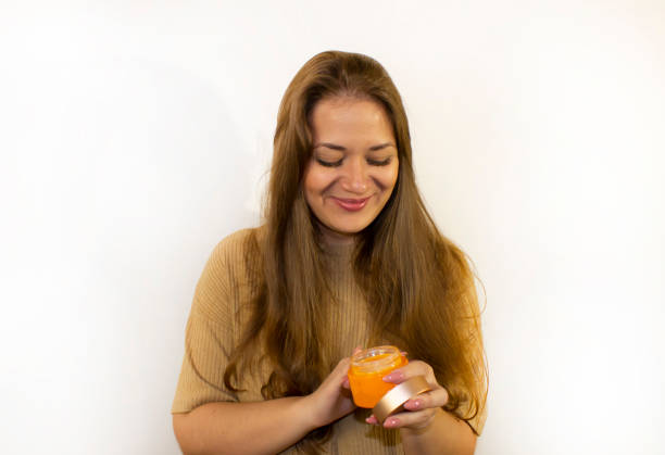 istock young beautiful woman uses face cream 1341851280