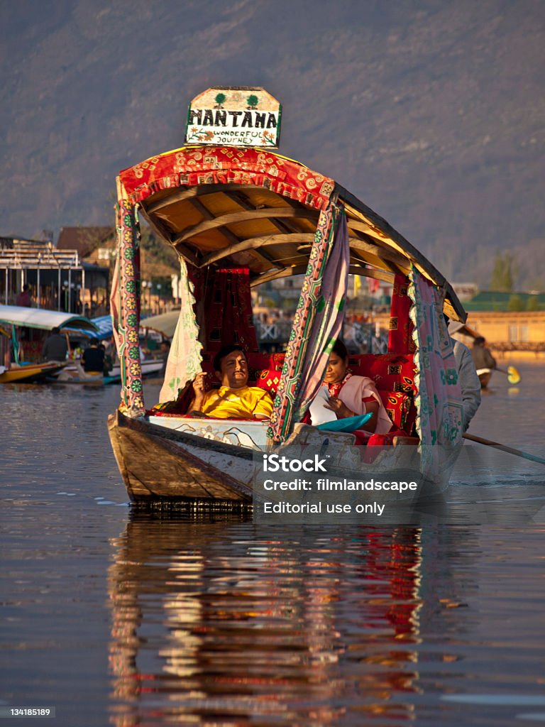 Dal Lake Srinagar, Kashmir, India - April 10, 2009: Lifestyle in Dal lake, the tourist attractive destination in northern India. Local people and tourist are necessary to use \'Shikara\', a small boat for traveling and transportation in the lake. Comfortable Stock Photo