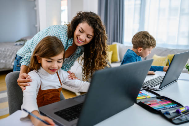 istock Mother helping her kids with online schooling 1341852458