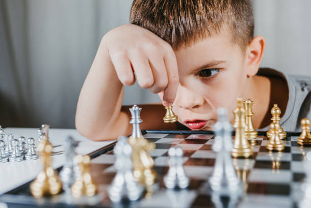 istock Child plays chess in his room at home 1341852727
