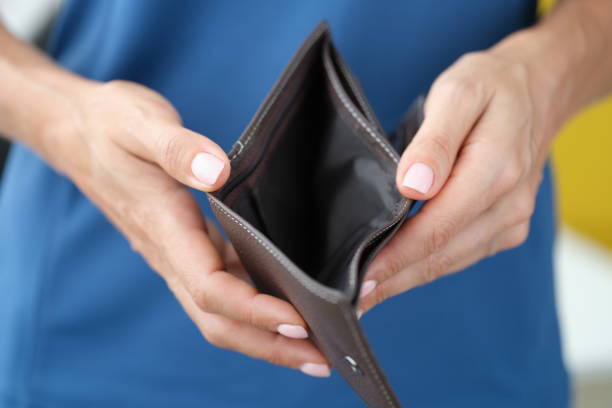 istock Business woman holding empty open wallet in hands closeup 1341853152