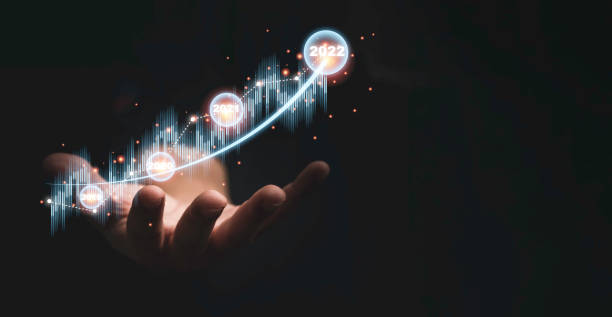 istock Trader hand holding virtual stock market graph chart on dark background for technical investment analysis concept. 1341853996
