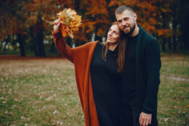 istock Elegant couple spend time in a autumn park 1341854057