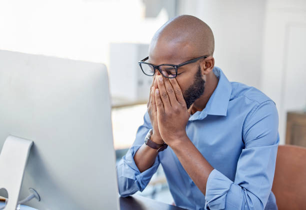 istock Shot of a businessman looking stressed while sitting at his desk 1341854829