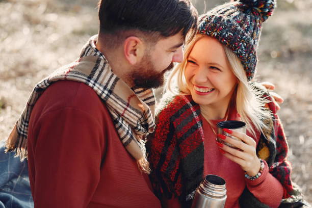 istock Couple sitting by the tree in a spring forest 1341855568