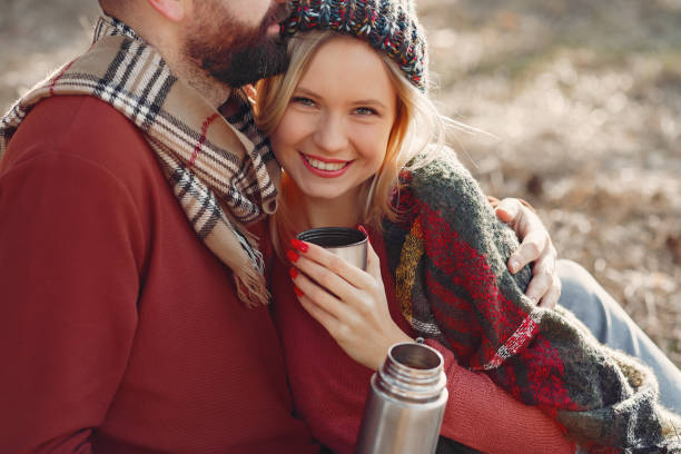 istock Couple sitting by the tree in a spring forest 1341855581
