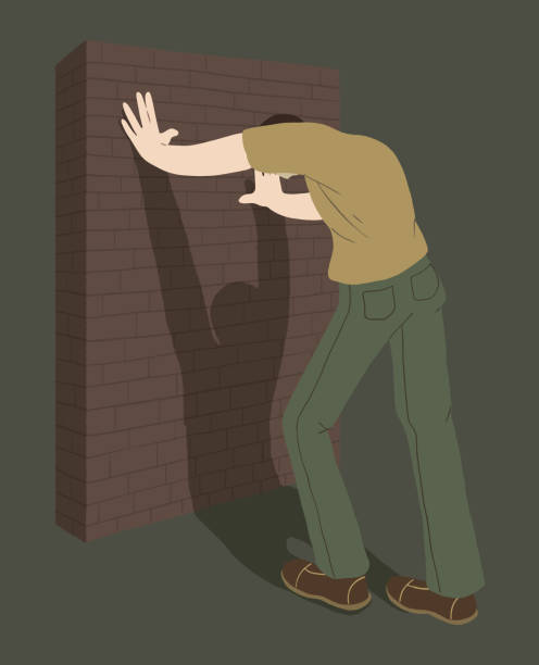 The man leans against the wall in despair. The young man stands with his head down. Vector. The man leans against the wall in despair. The young man stands with his head down. Illustration of powerlessness, fatigue from piled up problems. Vector. break down wall stock illustrations