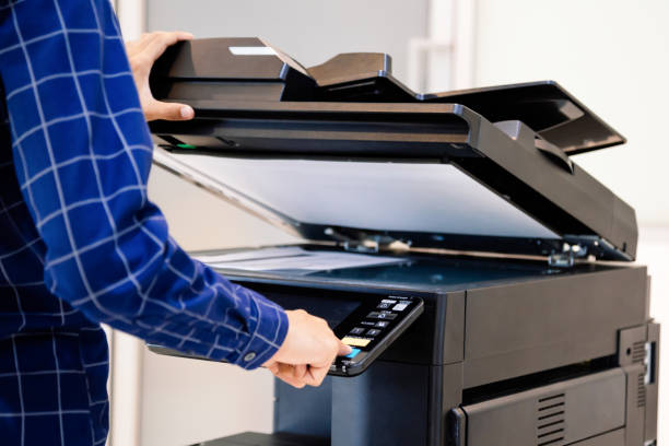 istock Businessmen press button on the panel for using photocopier or printer for printout and scanning document paper at office. 1341861275