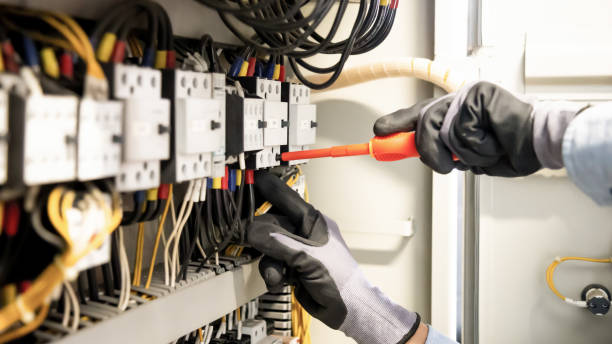 istock Electricians work to connect electric wires in the system, switchboard, electrical system in Control cabinet. 1341862375