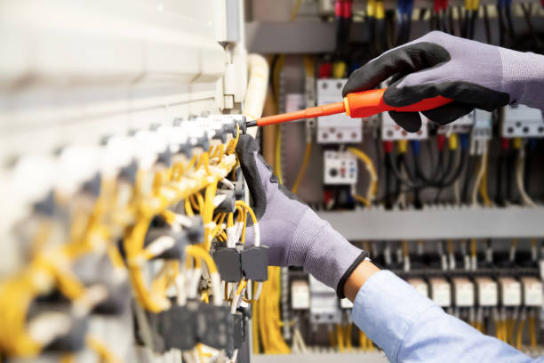 istock Electricians work to connect electric wires in the system, switchboard, electrical system in Control cabinet. 1341862425