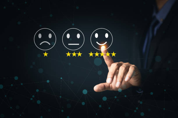 istock Customer Service and Satisfaction Concept Businessmen touch the virtual screen on happy smiley icons to achieve service satisfaction and feedback with excellent rated reviews. 1341862435