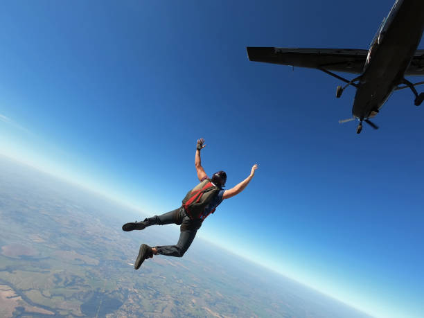 istock Skydiver jumps from a black plane on a hot day with clear skies. 1341864163