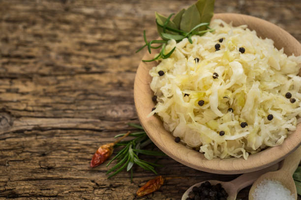 healthy sauerkraut with black pepper and spices on the wooden table - 7678 imagens e fotografias de stock