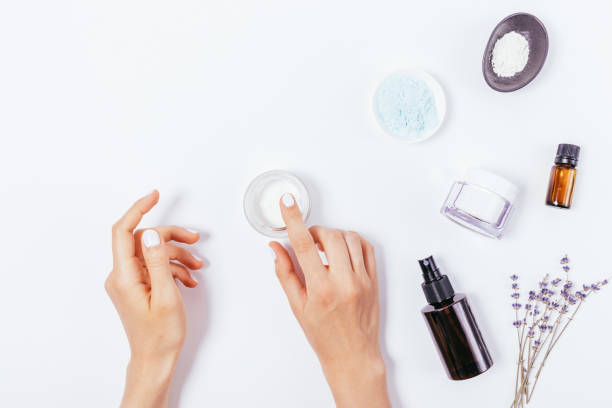 istock Female hands apply moisturizer next to lavender flowers 1341864595