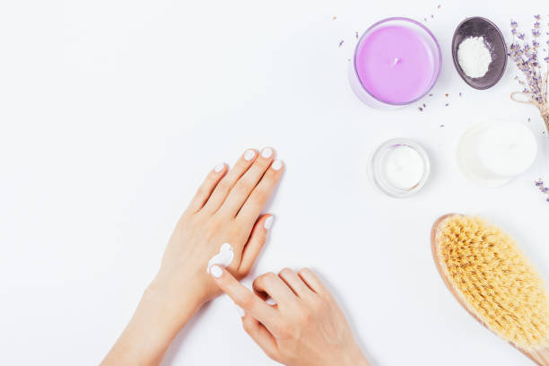 istock Female hands apply moisturizer next to lavender flowers 1341864606