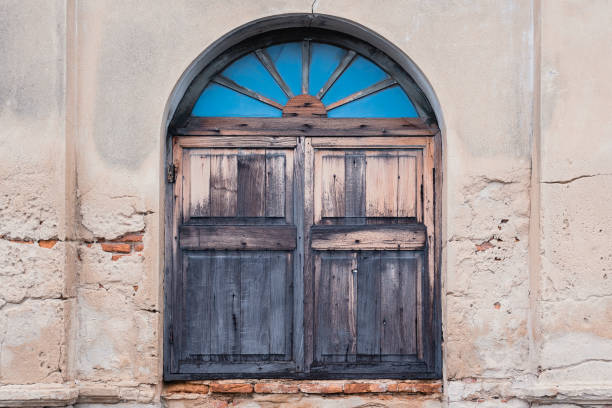istock Old big window on the antique wall background 1341866207
