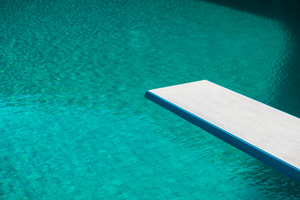 Springboard at swimming pool on the summertime Springboard at swimming pool on the summertime diving board stock pictures, royalty-free photos & images