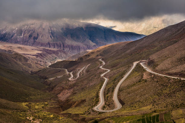 Dangerous mountain road with many turns between the mountains in an expressive cloudy day. Cuesta del Lipán, Jujuy, Argentina.
