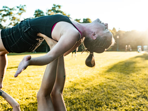 istock Two women practising Acro Yoga in the park 1341868209
