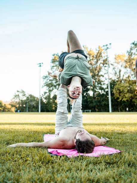 istock Young couple practising Acro Yoga in the park 1341868376