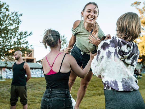 istock People practising Acro Yoga in the park 1341868506