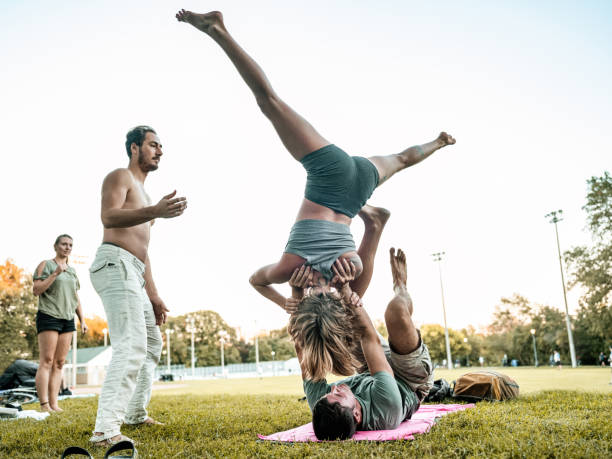 istock People practising Acro Yoga in the park 1341868646