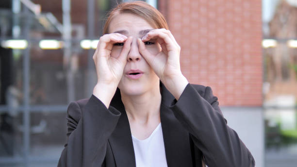 istock Binocular Gesture by Young Businesswoman 1341869768