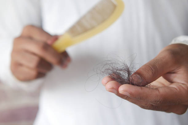 man hold his list hair close up