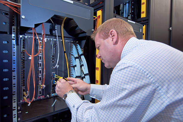 IT technician with network equipment and cables stock photo