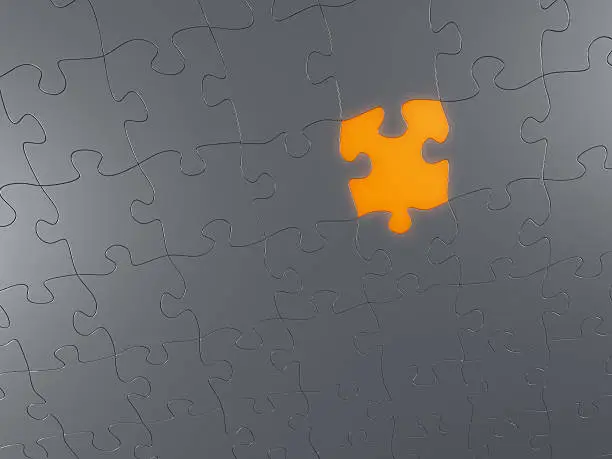 High resolution 3d render of an puzzle made of metal with one orange illuminated piece.