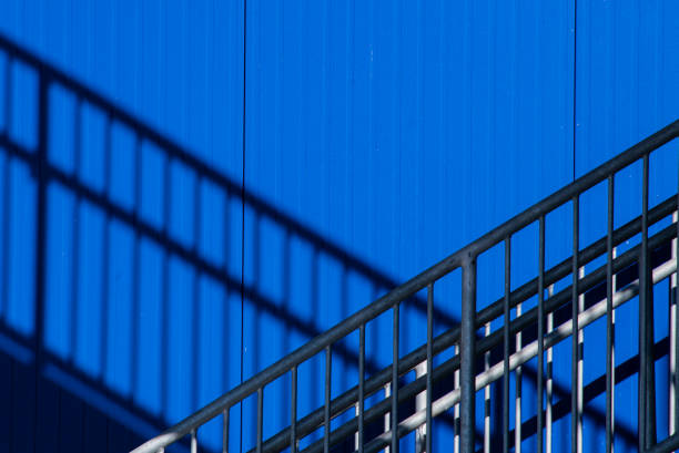 istock Abstract Staircase with Bright Blue Wall and Shadows 1341873314