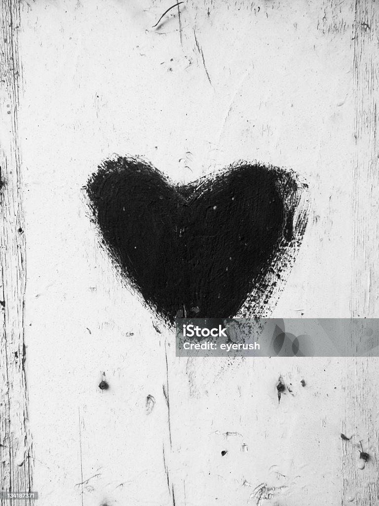 dark desire black heart shape on an old wooden window Barn Stock Photo