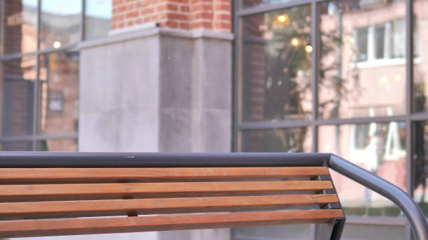 istock Empty Bench Near Loft Building in Background 1341873719