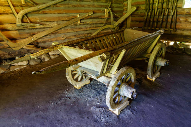 old wooden cart for transporting materials in the field. old wooden cart for transporting materials in the field. wagon wheel bench stock pictures, royalty-free photos & images