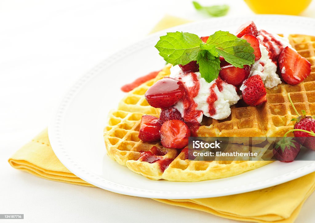 Belgian waffles Plate of belgian waffles with fresh strawberries and whipped cream Belgian Culture Stock Photo