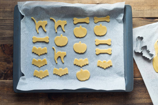 istock Making cookies in different shapes for Halloween. Cookies cut before baking. Copy space. 1341877284