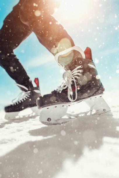 Particles of snow and ice from under hockey skates Particles of snow and ice from under hockey skates during a dynamic game on the ice of a lake hockey skates stock pictures, royalty-free photos & images