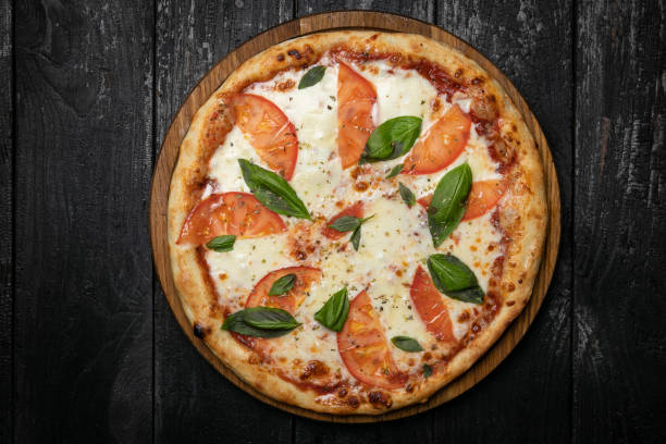 istock margarita pizza on a wooden board 1341878799