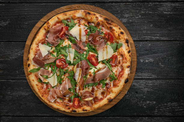 istock pizza with meat, parmesan and tomatoes 1341878941