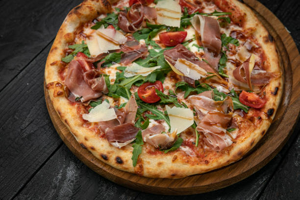 istock pizza with meat, parmesan and tomatoes 1341878945