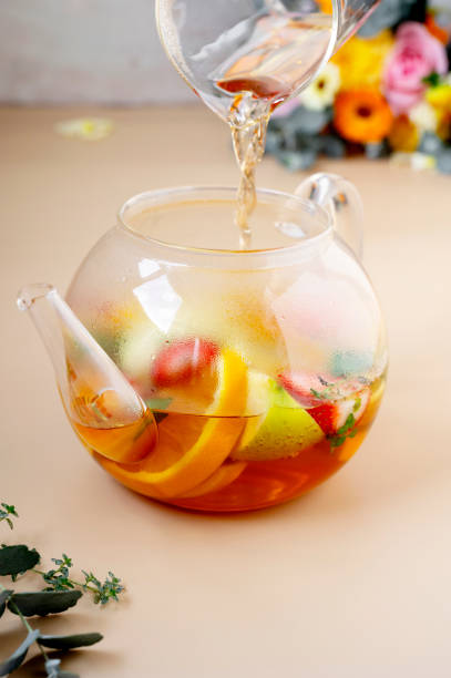 istock Black fruit tea in glass teapot with fresh fruit slices and eucalyptus leaves. 1341879135