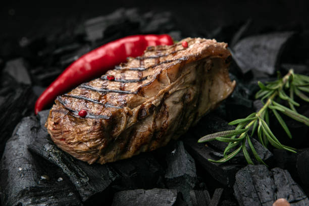 istock grilled steak on a  black charcoal 1341879994