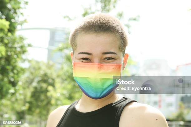 Asian Buzz Cut Woman Wearing A Rainbow Mask Stock Photo - Download Image Now - LGBTQIA People, Asian and Indian Ethnicities, Non-Binary Gender