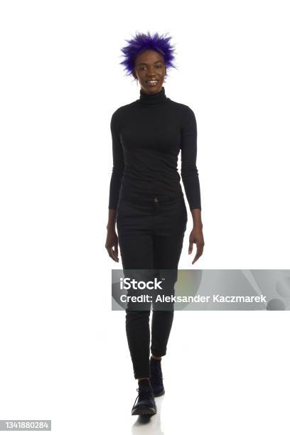 African American Woman In Black Clothes Is Walking Towards Camera Full Length Front View Isolated Stock Photo - Download Image Now