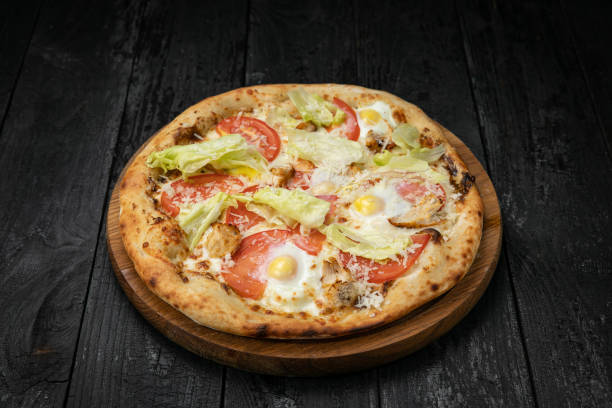 istock Italian pizza on a dark table 1341880617